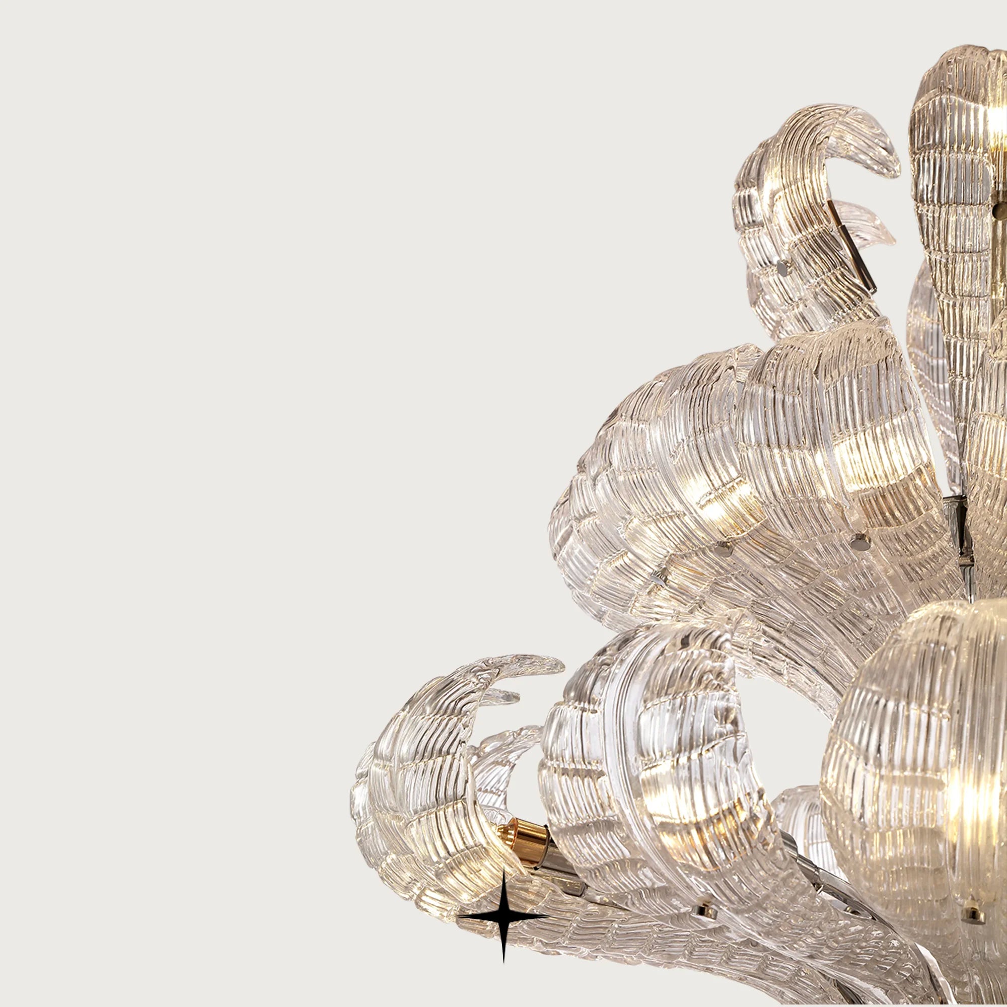 Angled close-up of illuminated crystal glass leaves on Grand Angelica chandelier