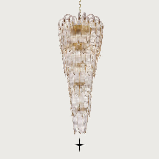Grand Oriana multi-tiered cascading wave-glass waterfall chandelier illuminated on light grey background