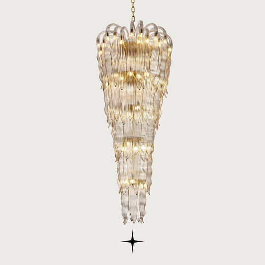 Grand Oriana multi-tiered cascading wave-glass waterfall chandelier illuminated on light grey background