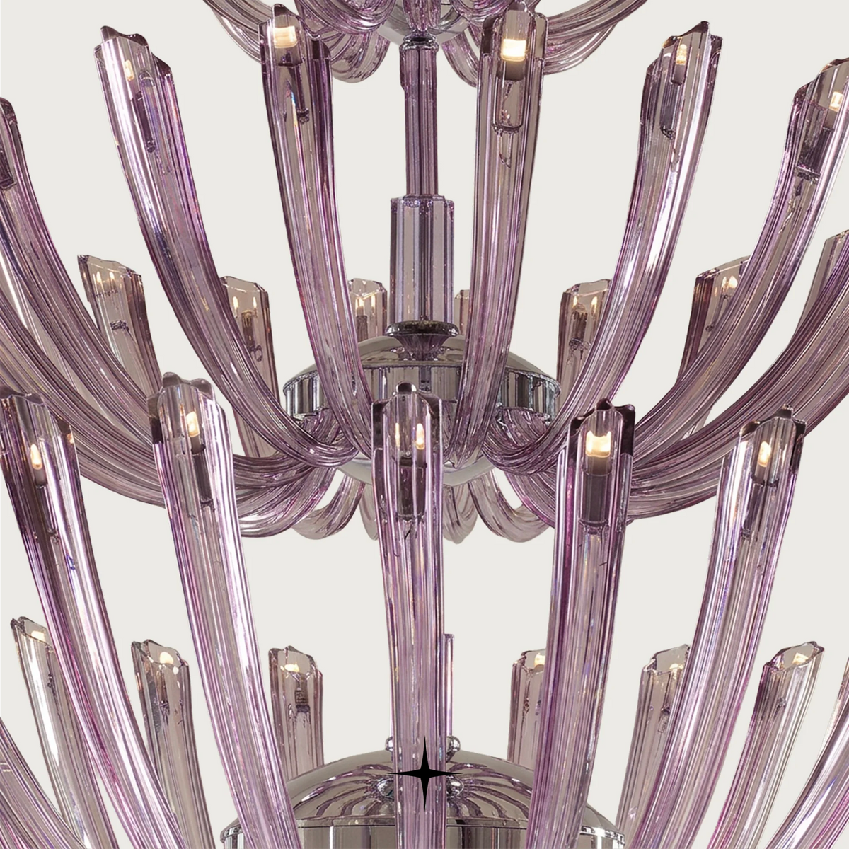 Grand Sienna Chandelier featuring chic elongated crystal arms available in five chandelier sizes and a wall lamp.
