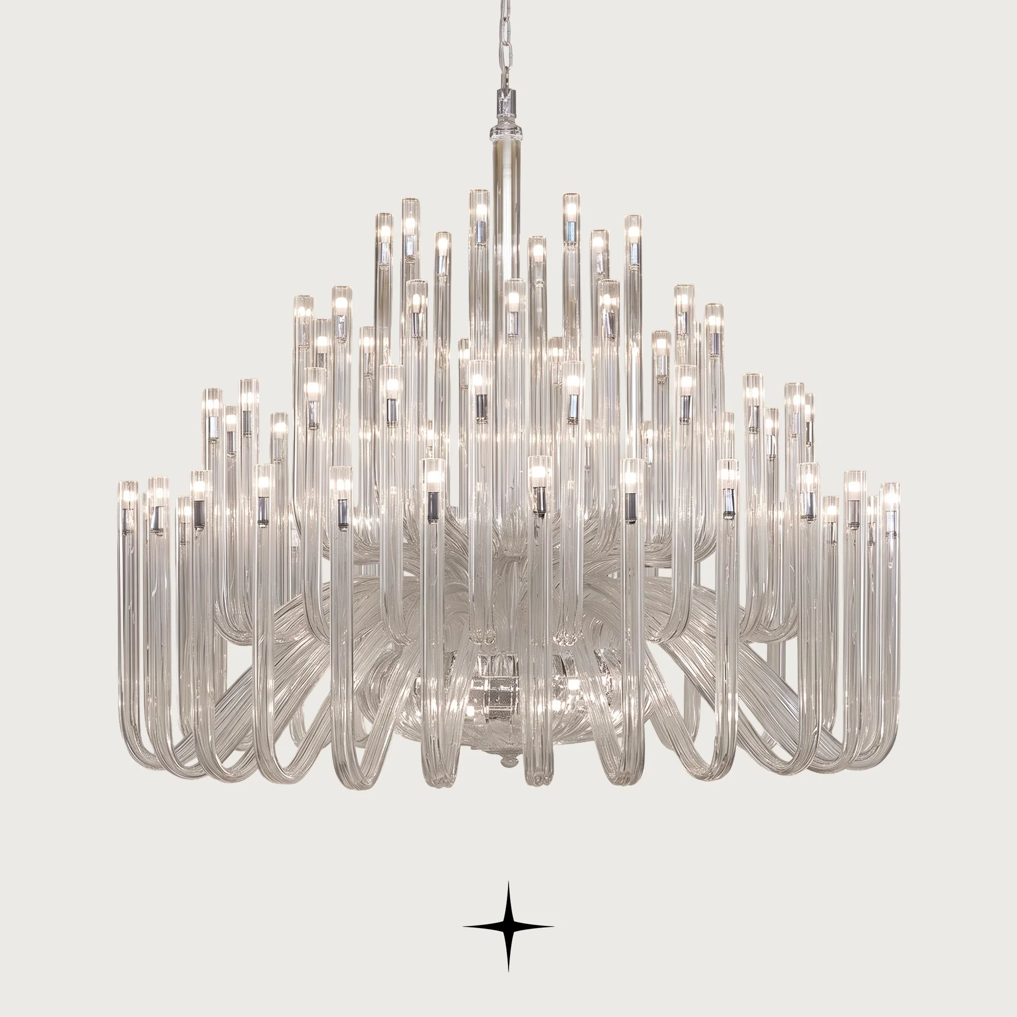 Grand Solara neo-classical crystal tube chandelier illuminated on a light grey background