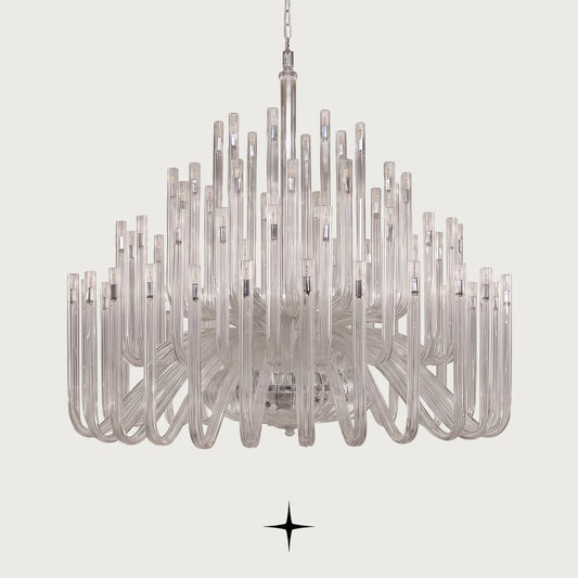 Grand Solara neo-classical crystal tube chandelier illuminated on a light grey background