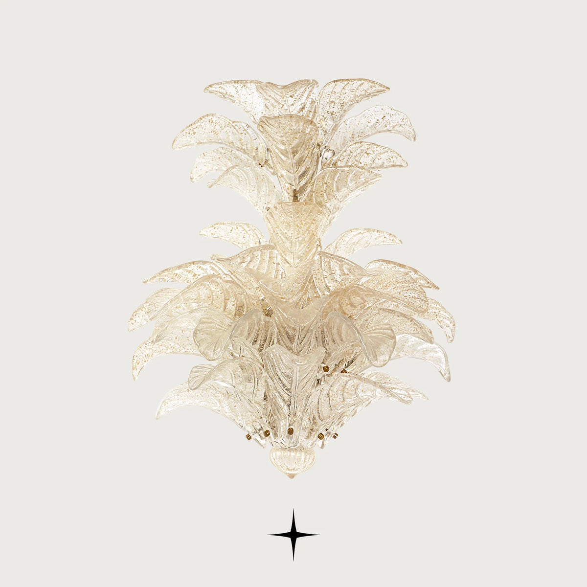 Lavish Madam gold-tinted glass leaf wall light illuminated on light grey backdrop