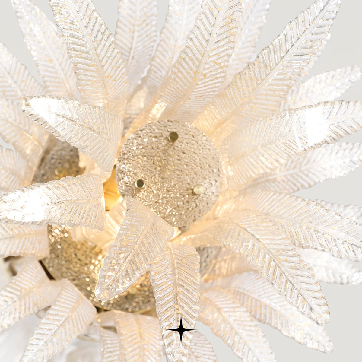 Close-up detail of handcrafted textured glass feather diffusers on Linear Golden Falls chandelier
