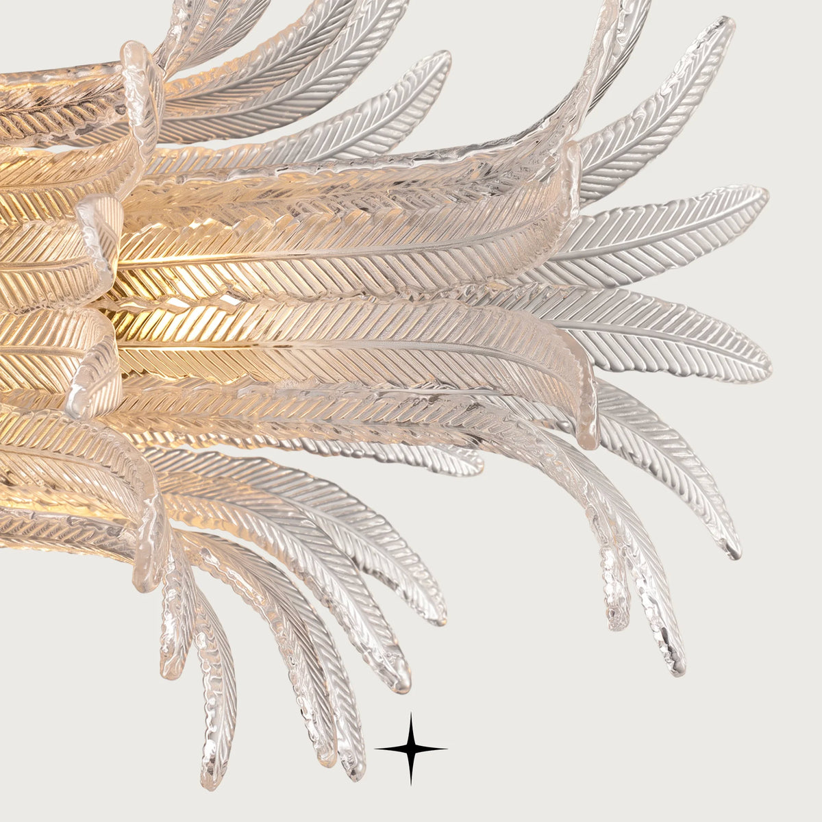 Close-up detail of handcrafted textured glass feather diffusers on Linear Golden Falls chandelier
