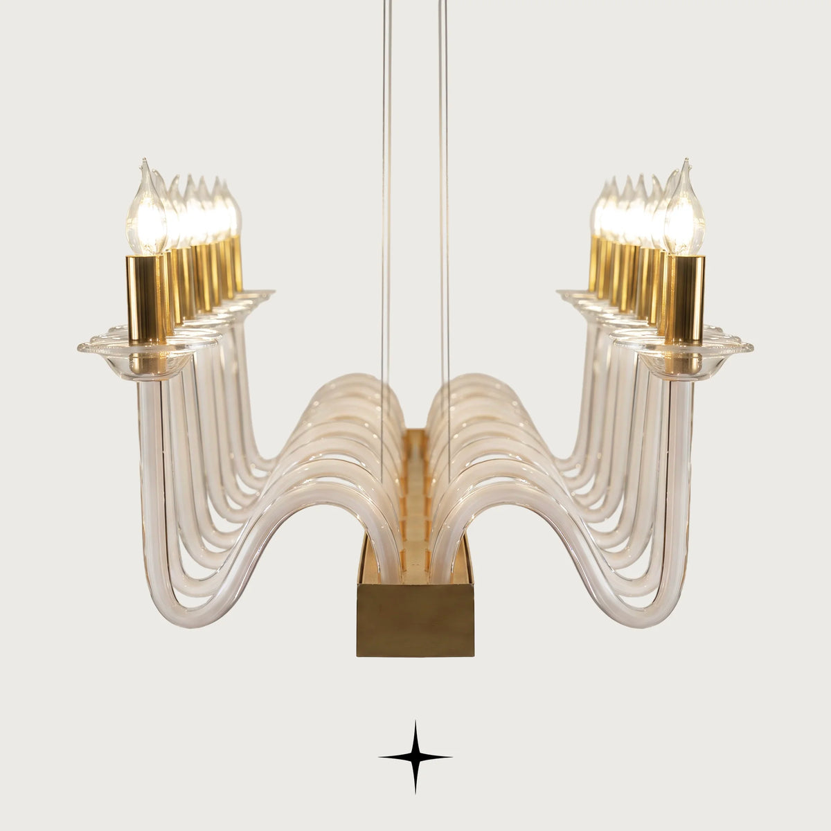 Angled view of illuminated crystal candelabra elements on gold brass frame