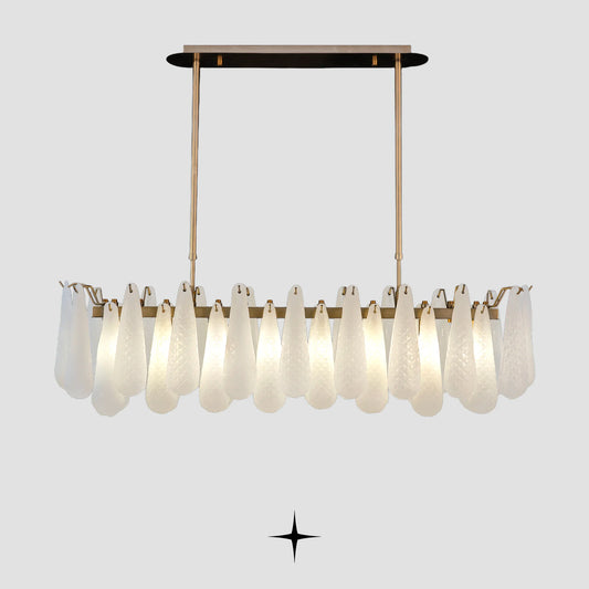 Linear Miranda horizontal brass chandelier with textured glass droplets on light grey background