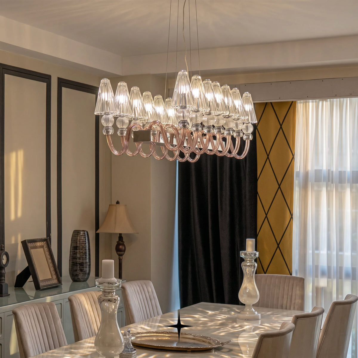 Linear Muse crystal chandelier suspended over a modern luxury dining space