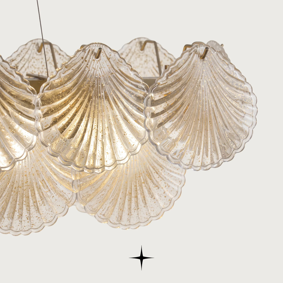 Close-up detail of illuminated textured seashell glass diffusers on Linear Shellina fixture
