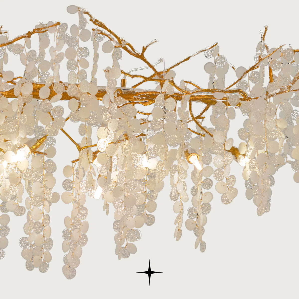 Close-up detail of textured gold brass branches and clear crystal clusters on Linear Shiraz chandelier