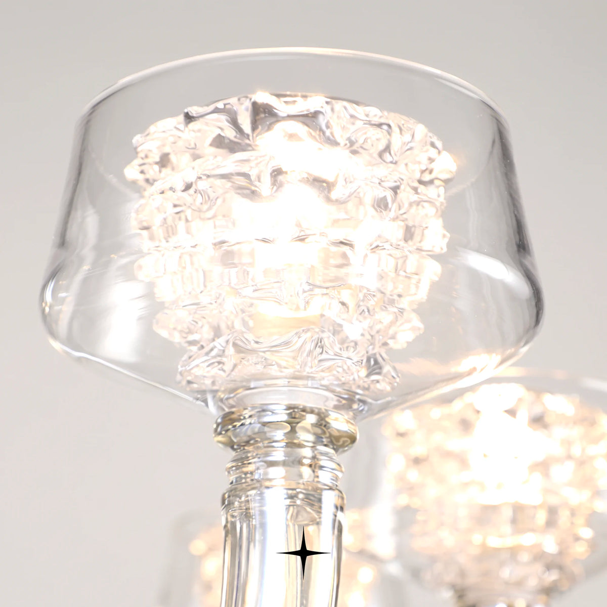 Close-up detail of illuminated fluted glass shade on Luna crystal chandelier
