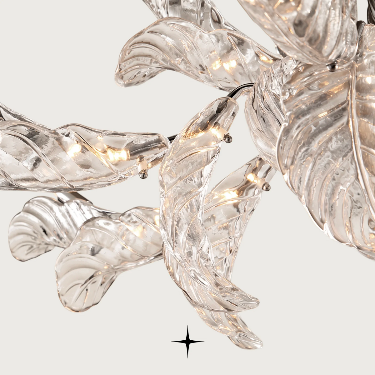 Top-angle view of delicate clear crystal leaf panels on the Madam chandelier
