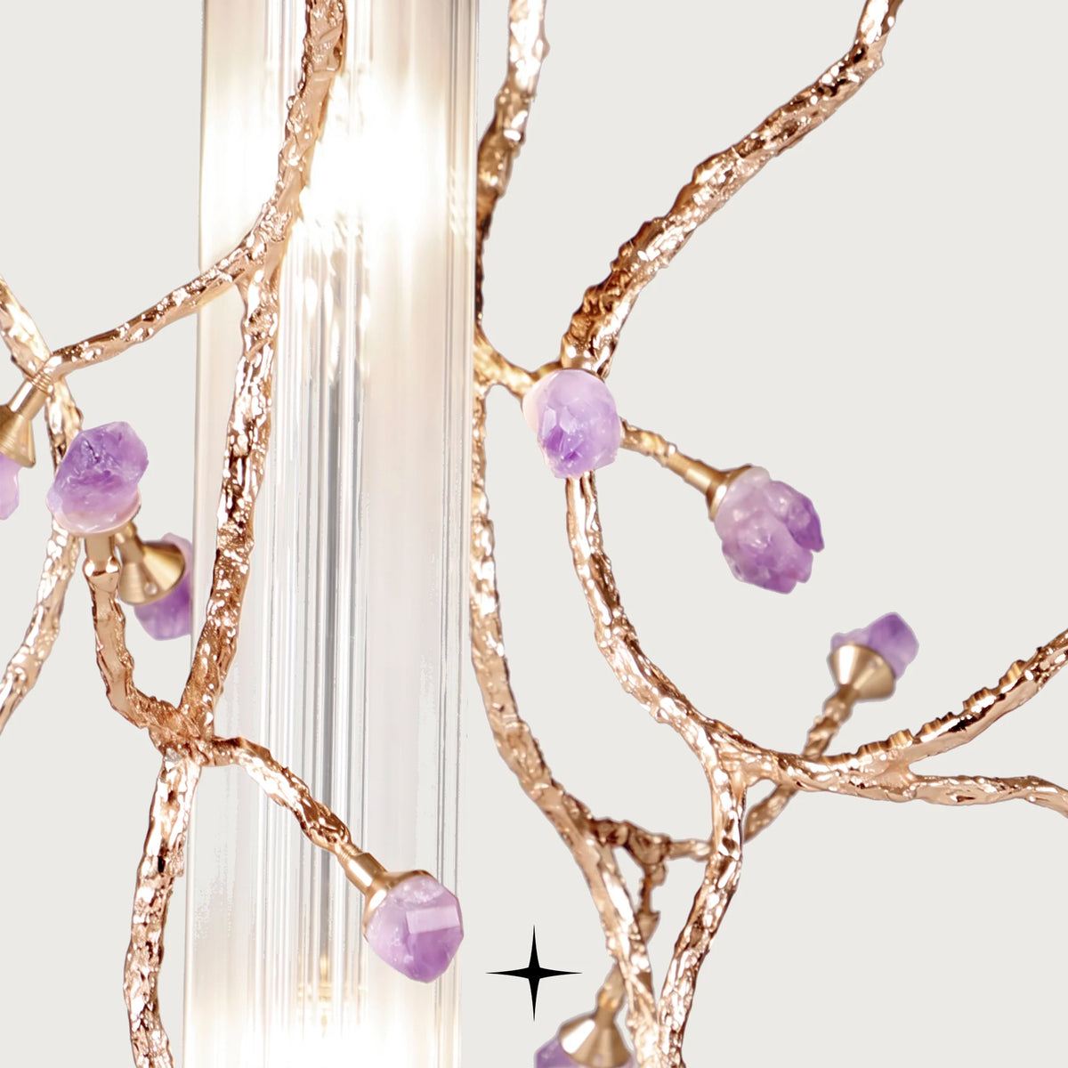 Close-up detail of lustrous brass branches, natural purple rocks, and ribbed glass on Madison pendant

