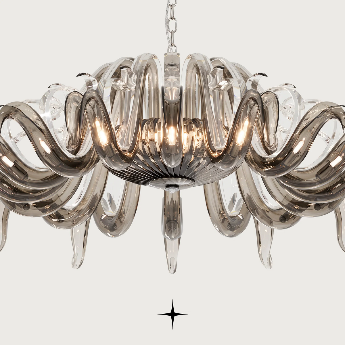 Majesty Chandelier featuring long curved clear dark crystal glass and 21 G9 LED lights.
