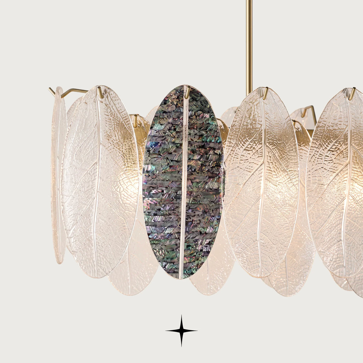 Detailed close-up of iridescent and clear glass leaves on Melina chandelier frame