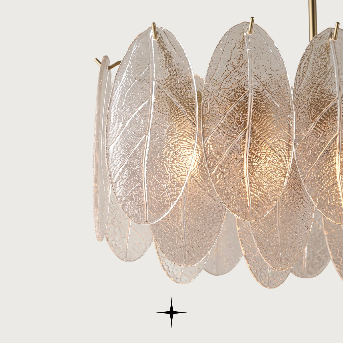 Detailed close-up of iridescent and clear glass leaves on Melina chandelier frame