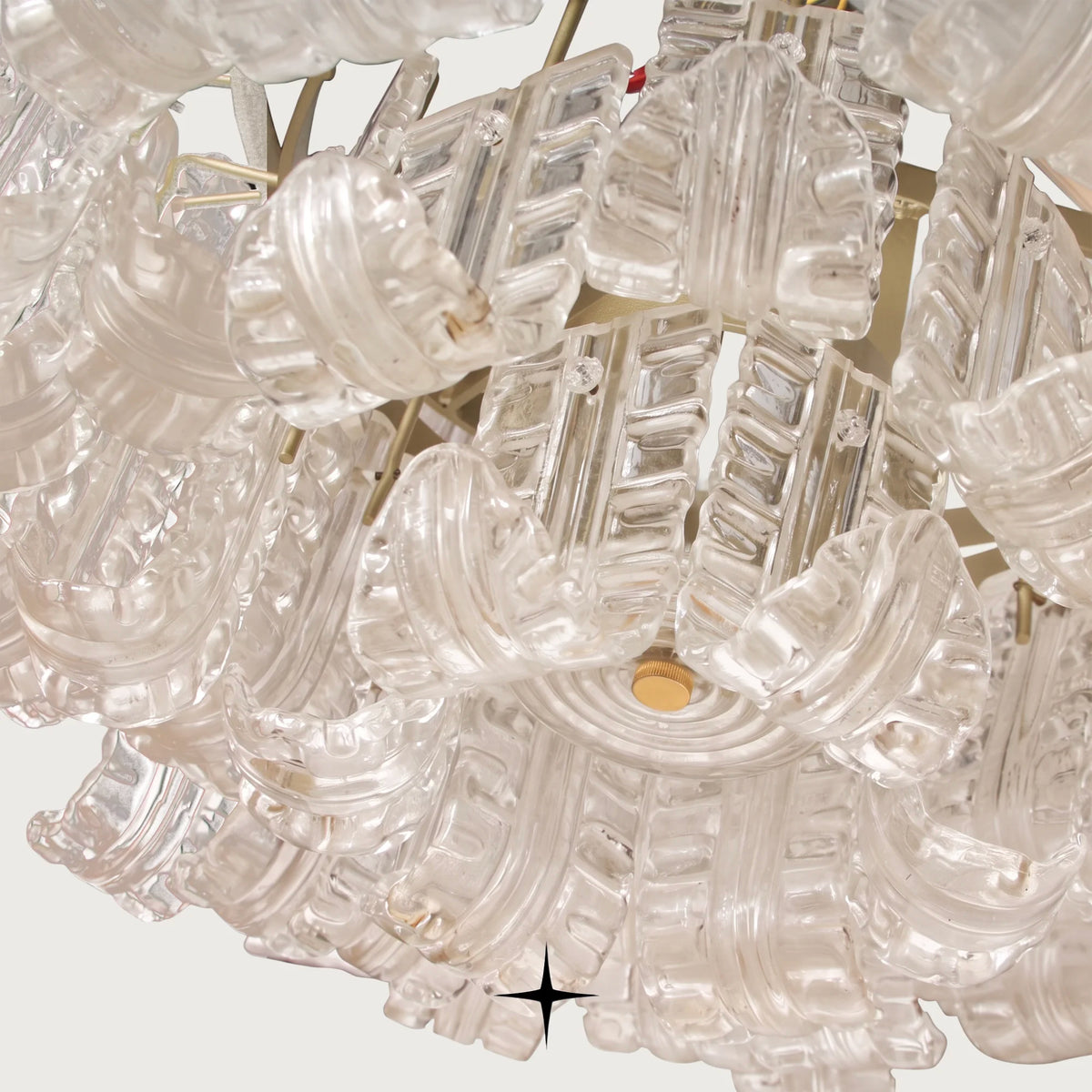 Close-up side detail of clear glass leaves on Montreal round chandelier
