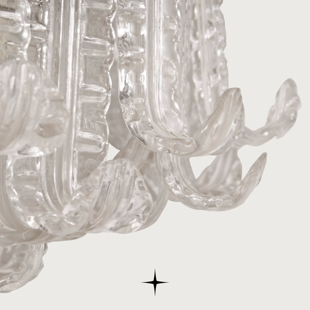 Close-up side detail of clear glass leaves on Montreal round chandelier
