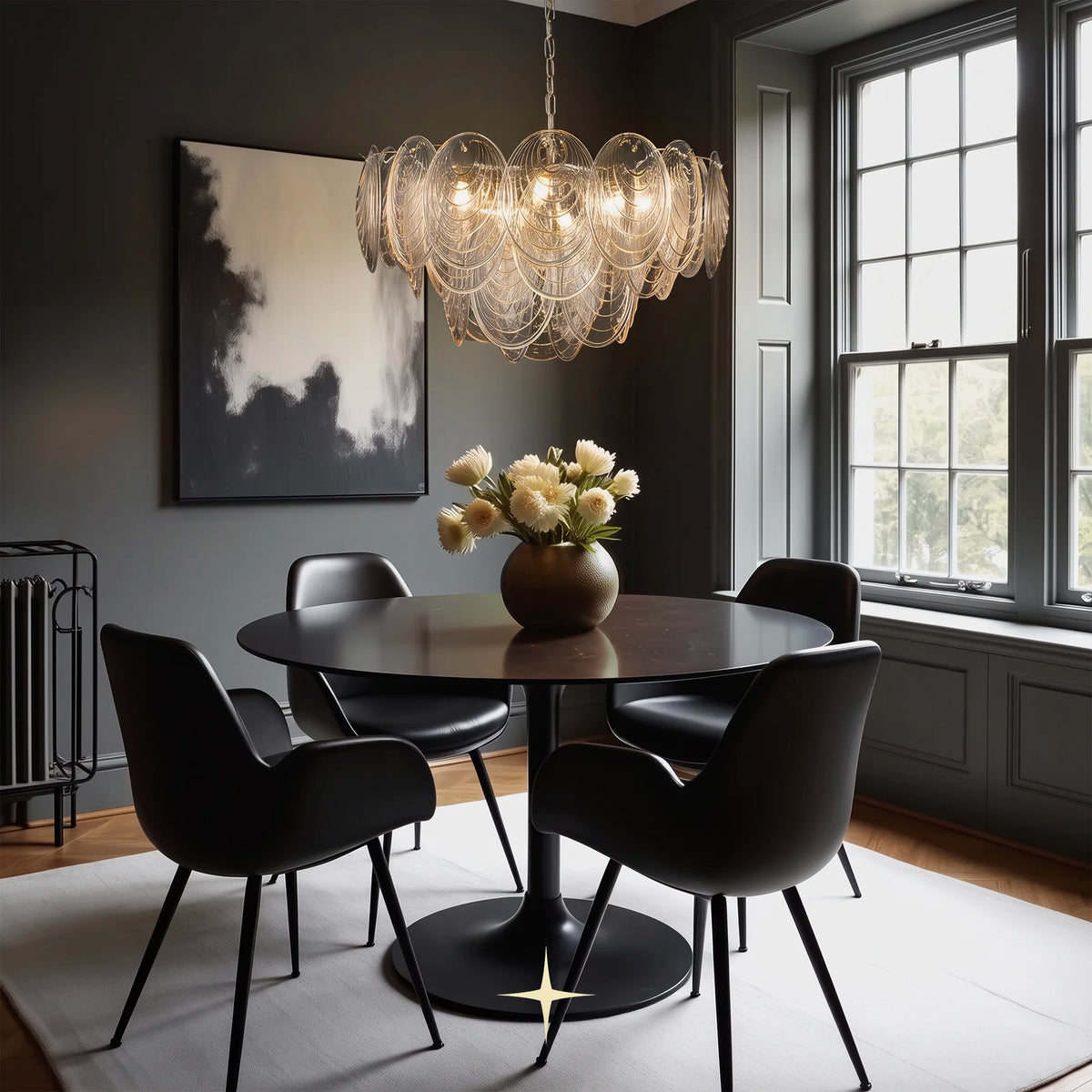 Moxie oval glass chandelier suspended over a round dining table set in a luxury room