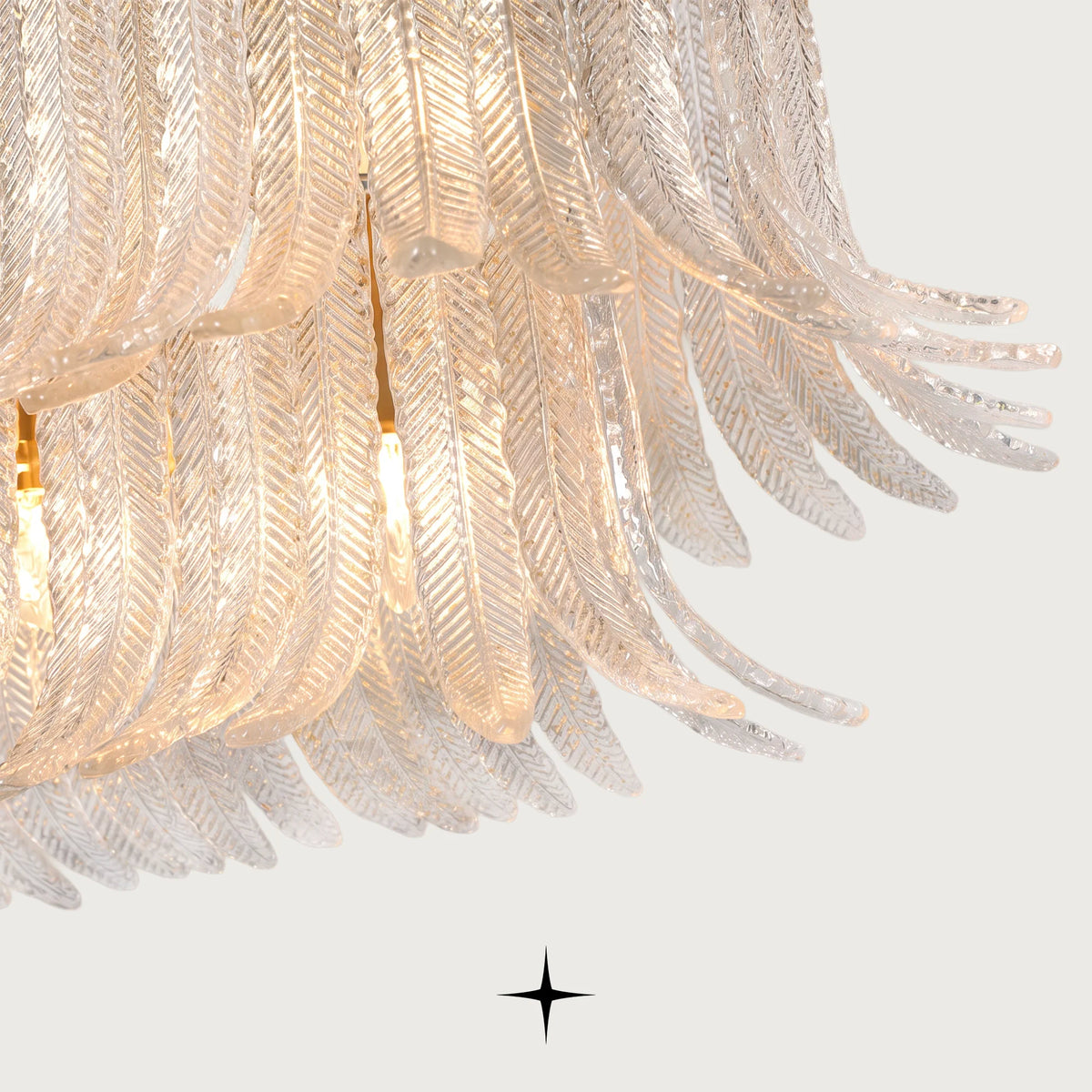 Close-up detail of layered glass feather elements on Oval Golden Falls chandelier
