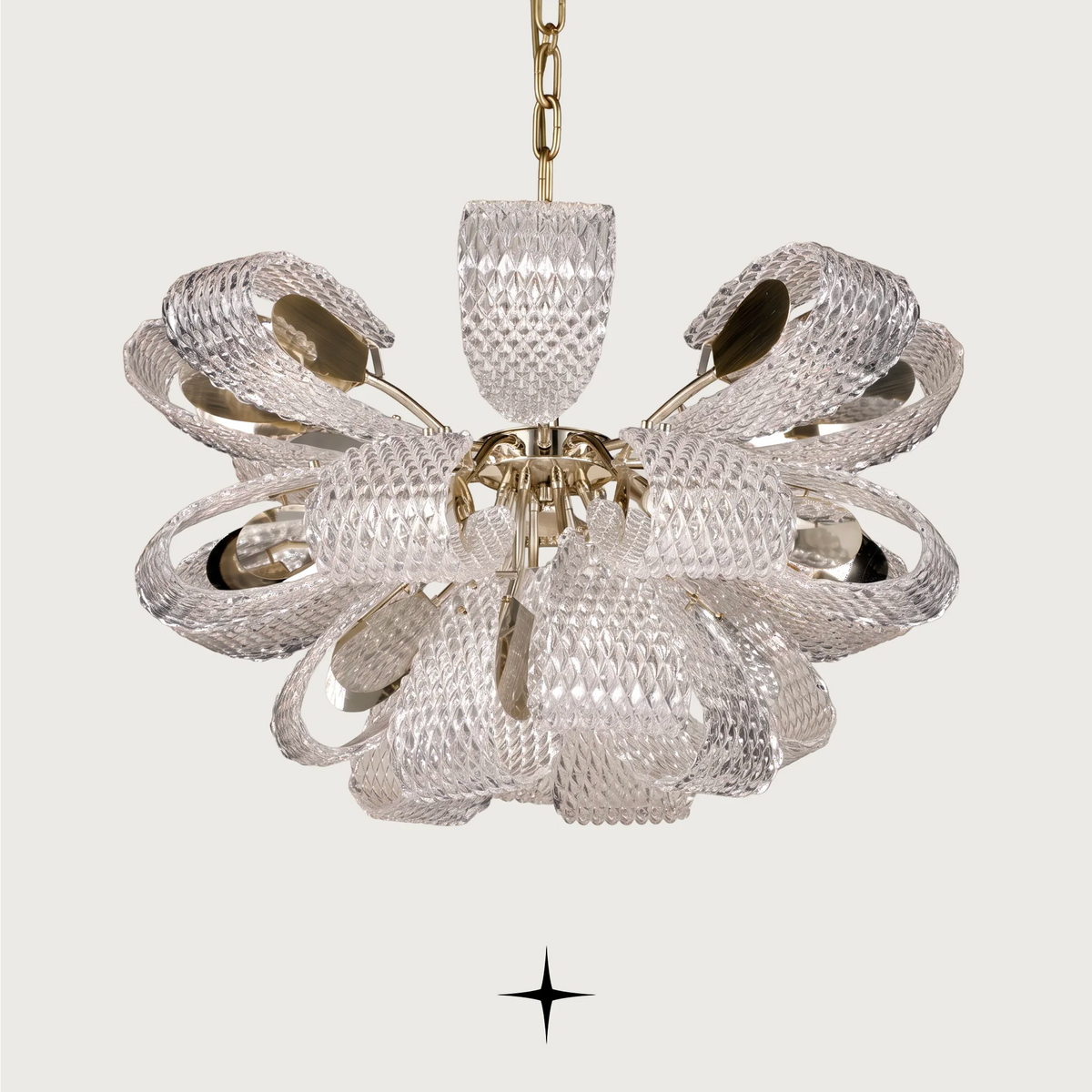 Side angle view of Papiyon chandelier showcasing curved glass petals and brass details
