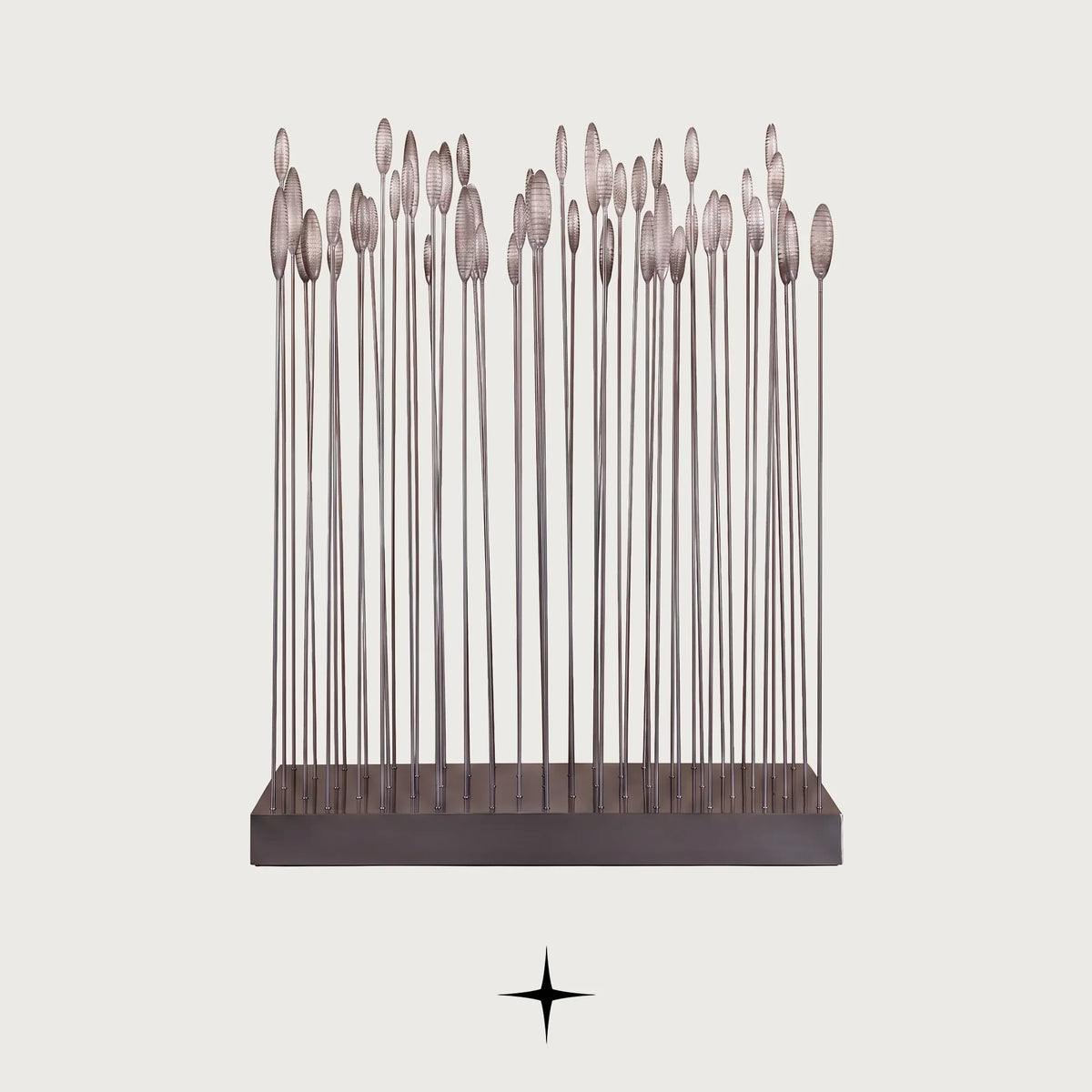 Reeda floor lamp with slender metal rods and illuminated glass flower tops on a light grey background