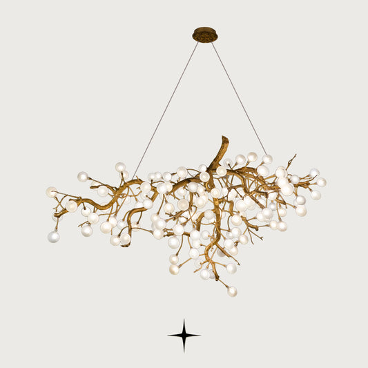 Romantica brass tree branch chandelier with crystal blossom bulbs on light grey background