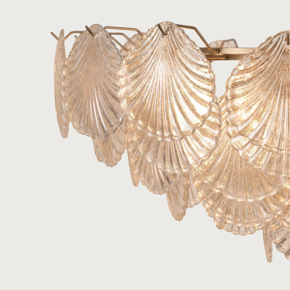 Close-up detail of textured seashell glass diffusers on Shellina chandelier
