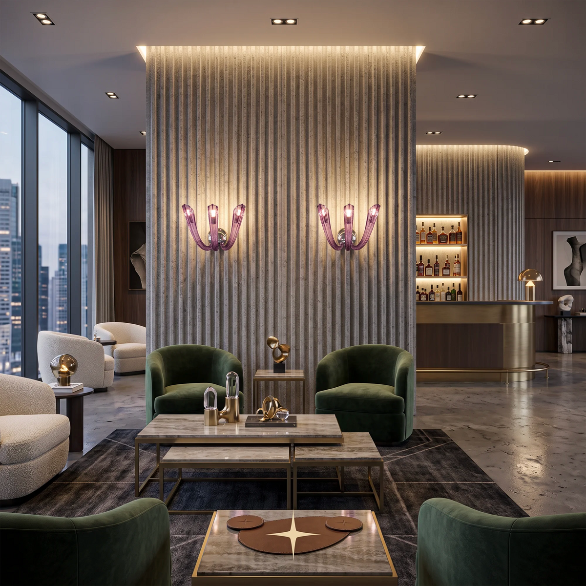 A luxury modern lounge interior with two green velvet armchairs centered in front of a tall ribbed illuminated wall panel, flanked by matching side tables and small gold sculptures. Two pink sculptural wall sconces are mounted on the wall.
