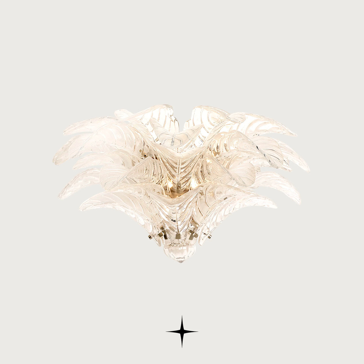 Sierra Murano style feather glass wall sconce with gold frame illuminated on a light grey background