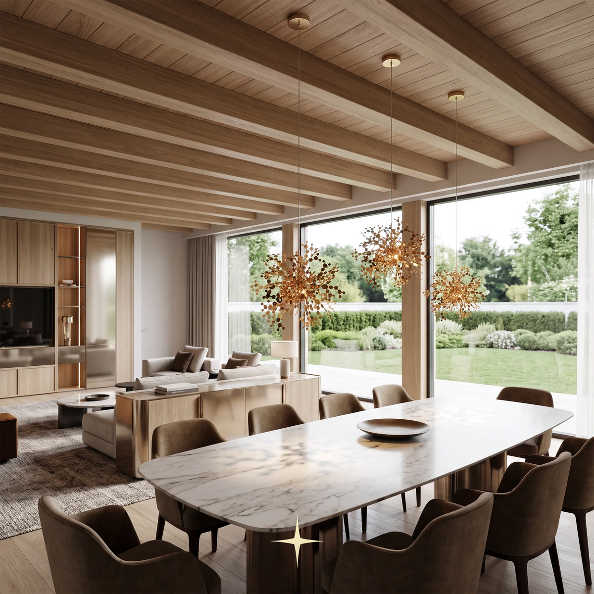 A modern dining room with a long marble-top table surrounded by upholstered chairs, under three sculptural gold pendant lights. Large windows overlook a landscaped garden, and the room has light wood ceiling beams and a matching living area in the background.