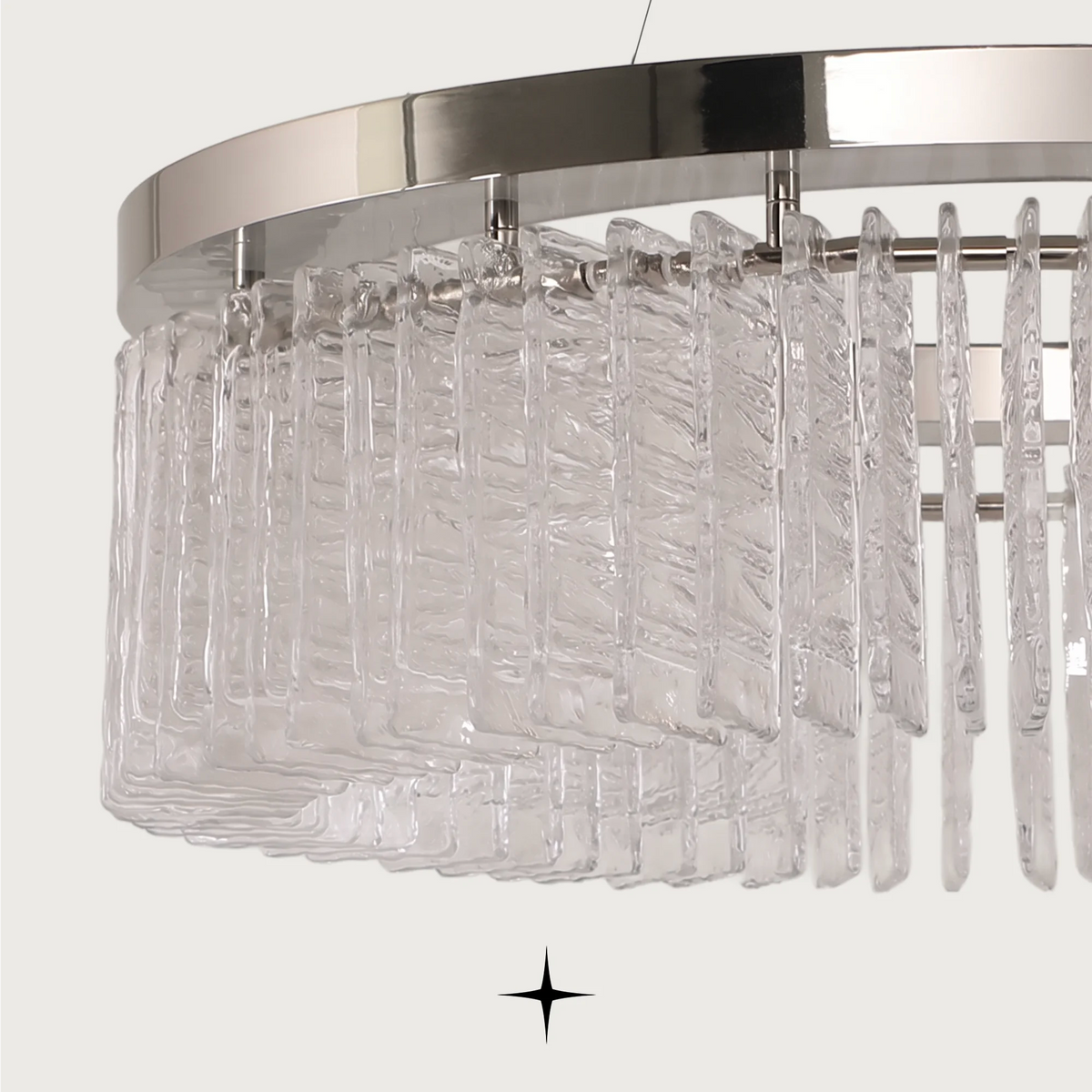 Detailed close-up of textured glass crystal prisms and polished metal trim on Waterfall chandelier
