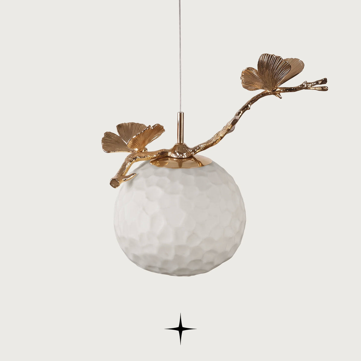 Zara single light pendant featuring handcrafted Murano glass ginkgo leaves and golden stem on black background