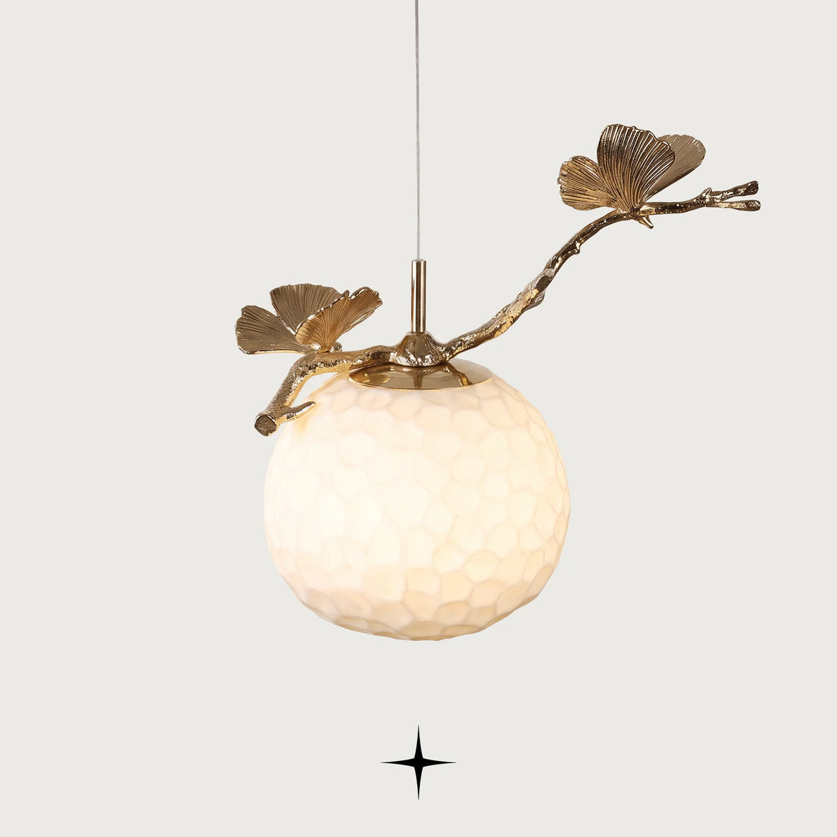 Zara single light pendant featuring handcrafted Murano glass ginkgo leaves and golden stem on black background